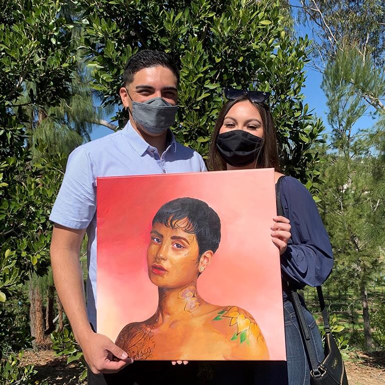 Picture of Robert Gabriel's clients holding a commissioned portrait together